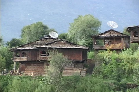 Satellite dishes sit atop vintage huts. Stock Footage