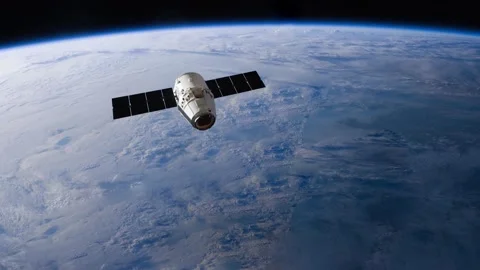 Satellite flying in outer space over cloudy Earth Video stock 152250480