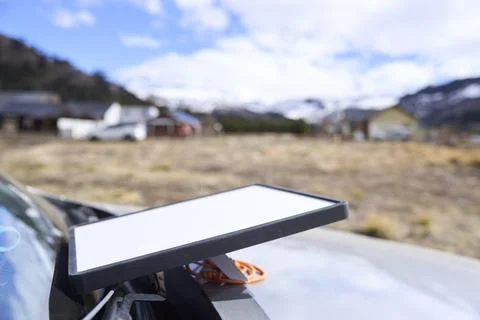 Satellite internet receiver antenna on the front of a car in a remote village Stock Photos