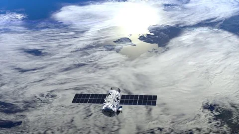 Satellite is orbiting the Earth. The view from the top. The satellite flies away Stock Footage 72570424