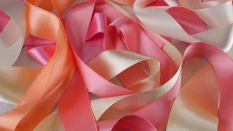Satin multi-colored ribbons rotate on display case.  Stock Footage 297429508