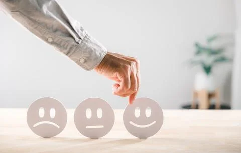 Satisfaction survey concept, hand selects happy face icon from options, sho.. Foto stock