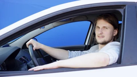 Satisfied and calm guy is looking at the camera and winking. Brunette man is Stock Footage 125093811