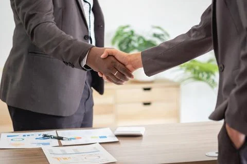 Satisfied black client shaking hands, thanking the manager for good financi.. Stock Photos