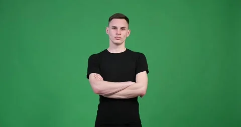 Satisfied caucasian man looking at camera on green background Stock Footage 248531681