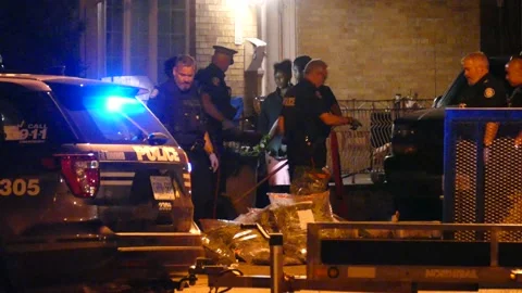 Satisfied cops take all the weed from stunned house residents in drug bust Stock Footage 136438385