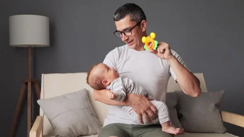 Satisfied dad posing indoors at home holding his newborn baby in his hands Stock Footage 291285747