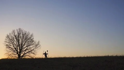 A satisfied farmer dances ib the field. Silhouette of a sunset or sunrise in Video stock 88280438