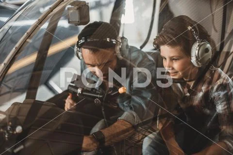 Satisfied father with boy in rotor plane Stock Photos