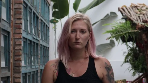 Satisfied girl with tattoos eats fruit. Stock Footage 119555911