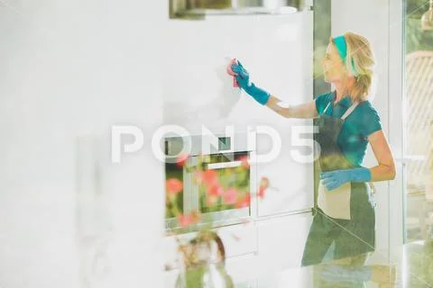 Satisfied housekeeper cleans Stock Photos
