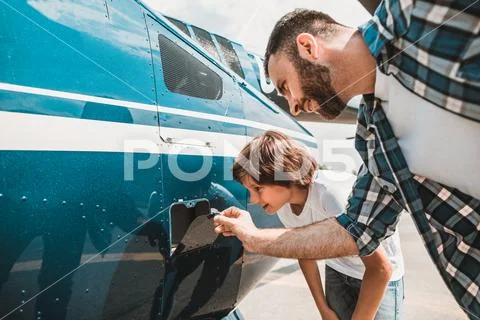 Satisfied man and boy watching petrol tank Stock Photos
