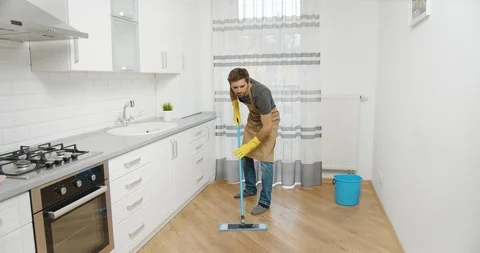 Satisfied Man Cleaning Kitchen Floor 動画素材 119778365