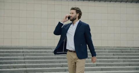 Satisfied Man hurrying, running on stairs and talking on his Phone.  Stock Footage 117690807