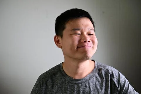 Satisfied man smiling with calm expression showing relief and confidence 스톡 사진