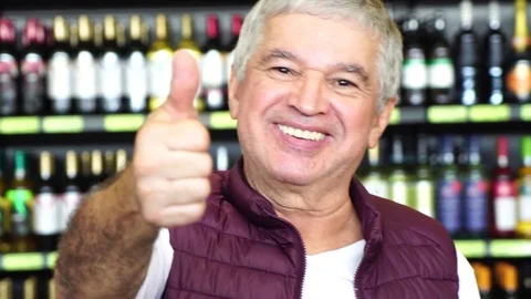 Satisfied Man Thumbs Up with Bottles on background Stock Footage 85168706