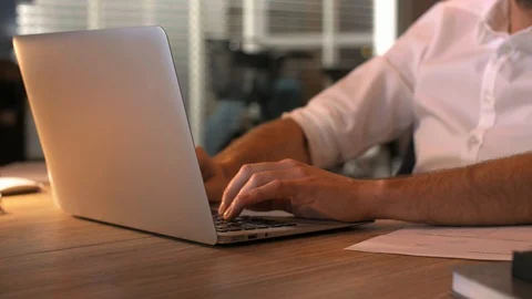 Satisfied man using laptop at night 動画素材 101324819