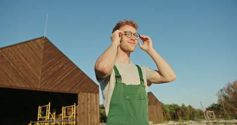 Satisfied man with work done by builder worker in eyeglasses and special uniform Video stock 142256690