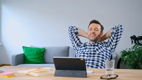 Satisfied man working with digital tablet from home office Stock Footage 126828162