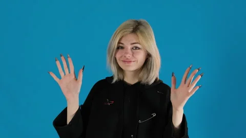 Satisfied model with bob dances with raised hands up to head Stock Footage 306503275