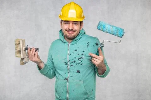 A satisfied painter has a big problem with the choice of tools Stock Photos