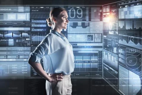 Satisfied programmer smiling at looking at her computer Foto stock