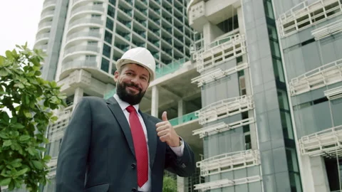 Satisfied with the result engineer looks at the camera smiling, builder Stock Footage 218323742