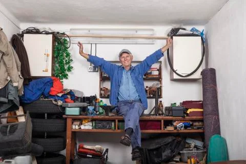 Satisfied senior worker in his workshop Stock Photos
