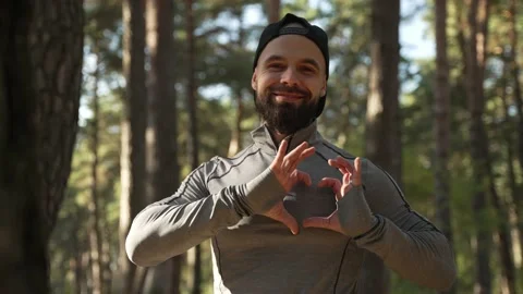 A satisfied smiling man shows that he loves everyone Stock Footage 225904079