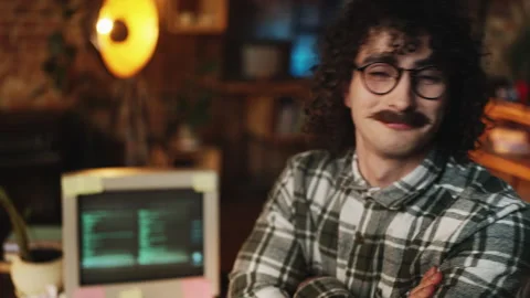 Satisfied software developer pointing at computer screen, startup founder Stock Footage 315456596