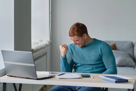 Satisfied with work done. Man working from home happily surprised looking at a Foto stock