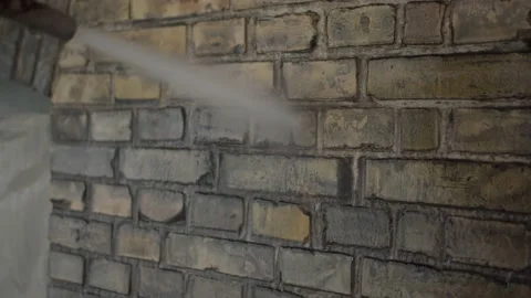 Satisfying cleaning of an old brick wall with a Pressure Washer. Stock Footage 196022070