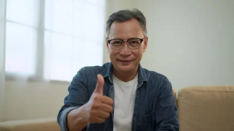 Satistified elderly man present thumbs up excellent, Happy asian senior man smil Stock Footage 265640047
