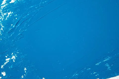 Saturated blue abstract background, applied toning primer on a white surface Stock Photos