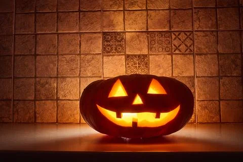 Saturated pumpkin on a dark background for the holiday Halloween. Illuminat.. Stock Photos