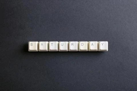 Saturday word on computer keys button. Flat lay view from above on the table Foto stock