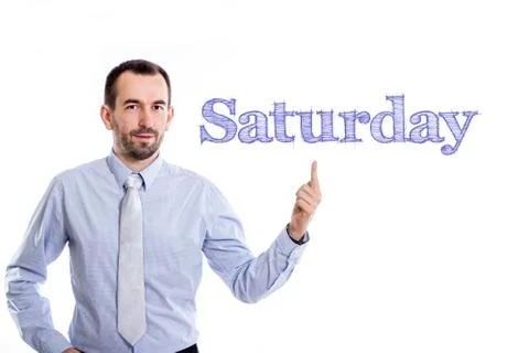Saturday - Young businessman with small beard pointing up in blue shirt Stock Photos