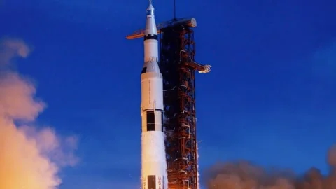 Saturn V rocket launching into the deep blue twilight sky. Stock Footage 328070927