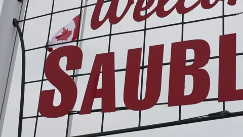 Sauble Beach Ontario sign with Canadian flag in the background Stock Footage