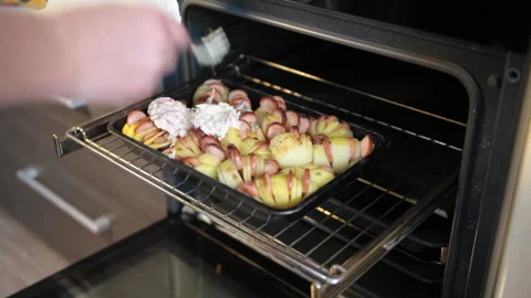 Sauce is applied to potatoes with sausages. Stock Footage 160964460