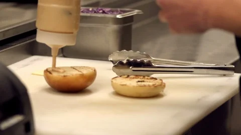 Sauce being added on buns Stock Footage 109327136