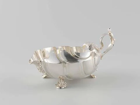 Sauce bowl in shell shape with three legs and ear. Sauce bowl of silver. T... Stock Photos