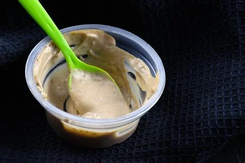 The sauce is in a disposable container. Stock Photos