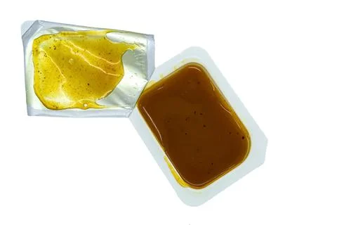 Sauce in a mini container on a white background close-up 스톡 사진