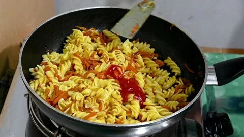 The sauce is poured over the pasta on the coking pan in slow motion. Yogurt  Stock Footage 218344800