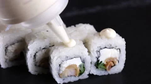 The sauce pours on the rolls the slow motion  rice sushi Stock Footage 168341897