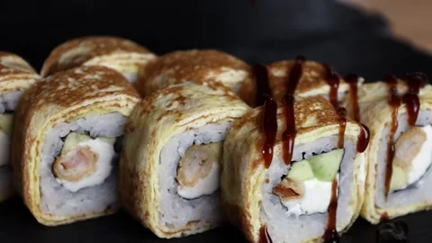 The sauce pours on the rolls the slow motion soy rice sushi Stock Footage 168341899