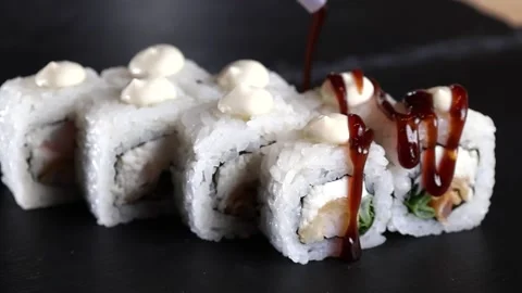 The sauce pours on the rolls the slow motion soy rice sushi Stock Footage 168341908