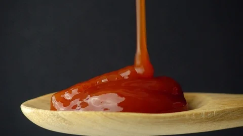 Sauce of red tomato falling into spoon on black background 스톡 동영상 89189249
