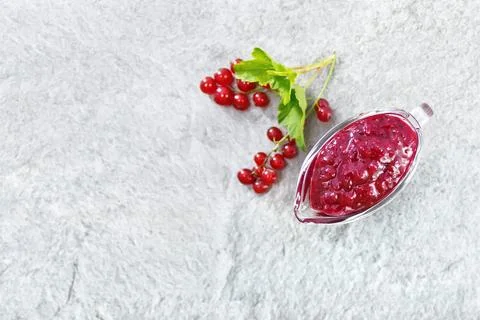 Sauce of redcurrant on stone table top Stock Photos